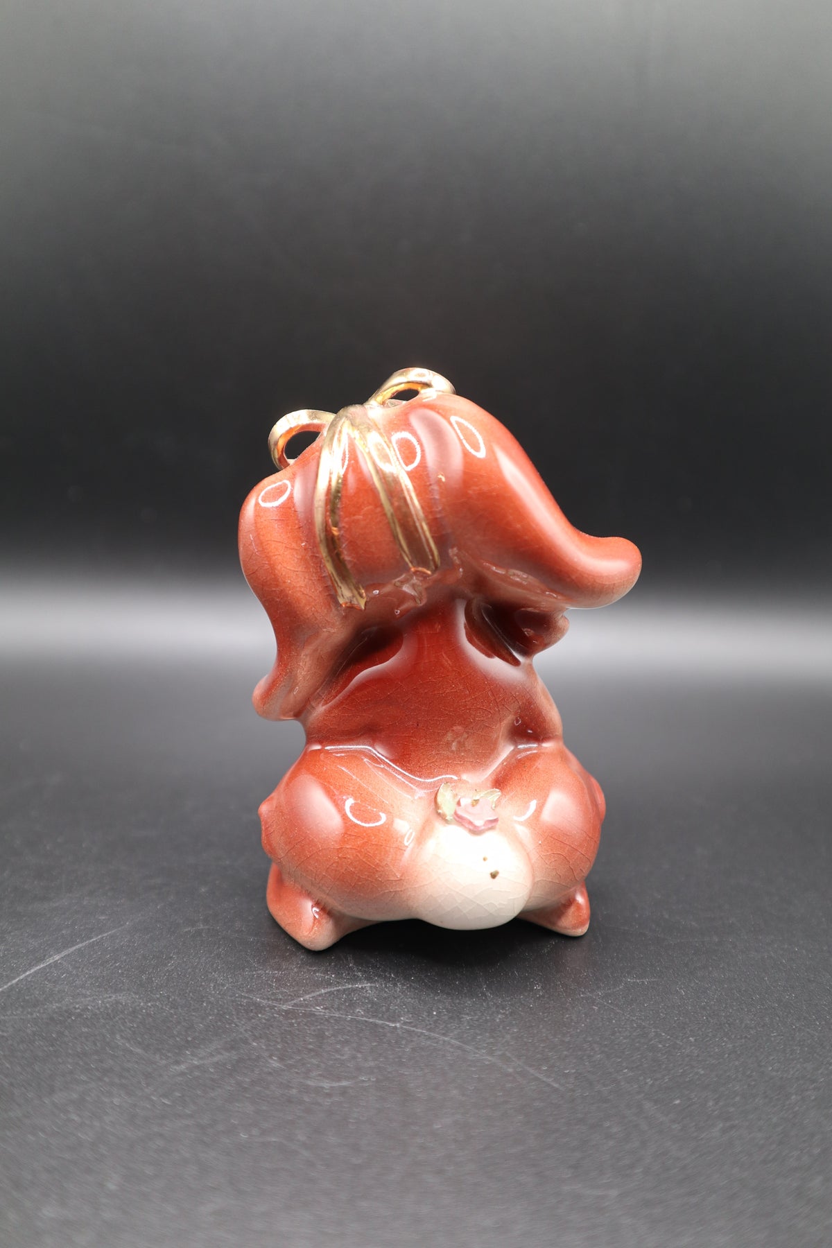 SMALL CERAMIC DOG WITH FLOWERS AND GOLD BOW