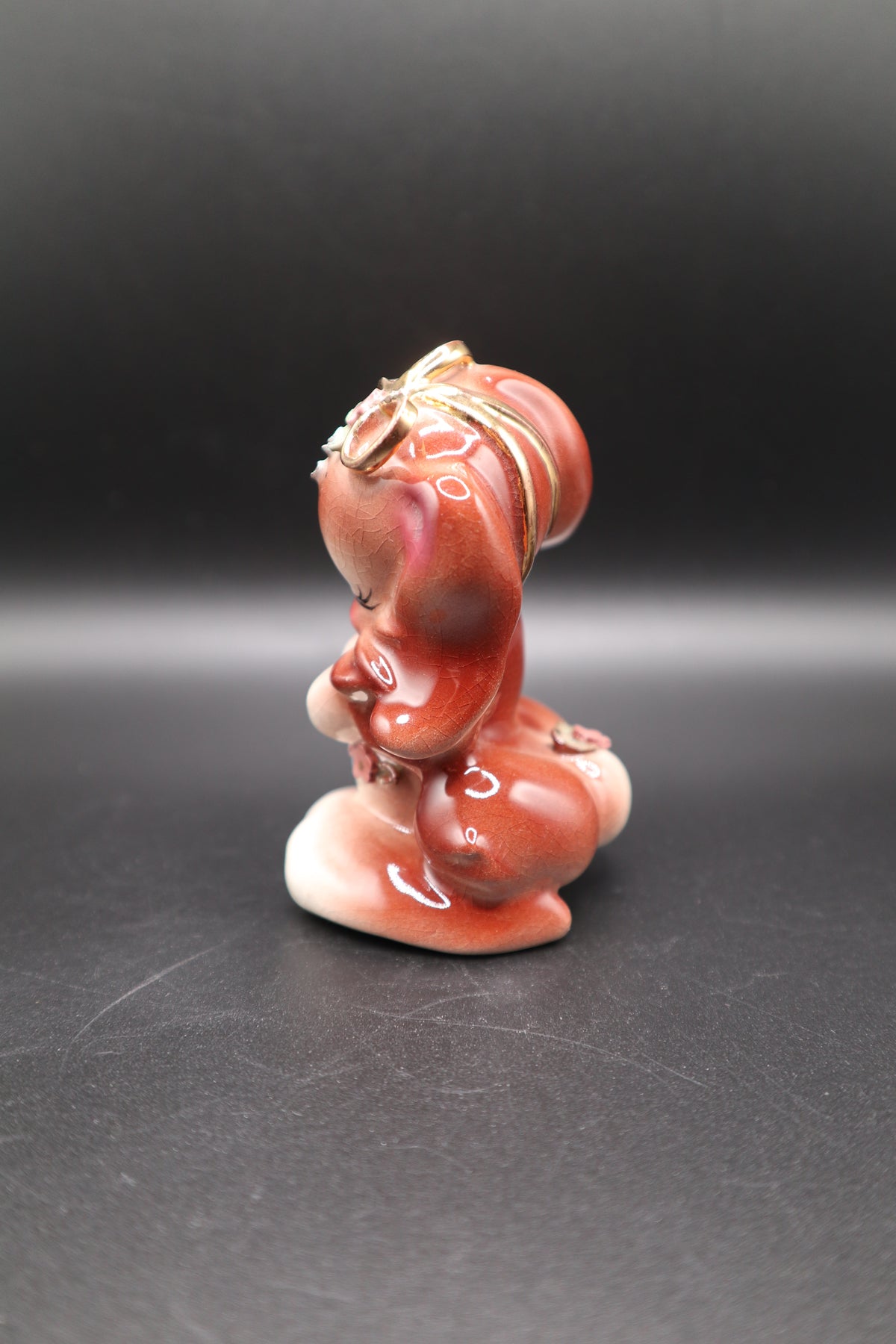SMALL CERAMIC DOG WITH FLOWERS AND GOLD BOW