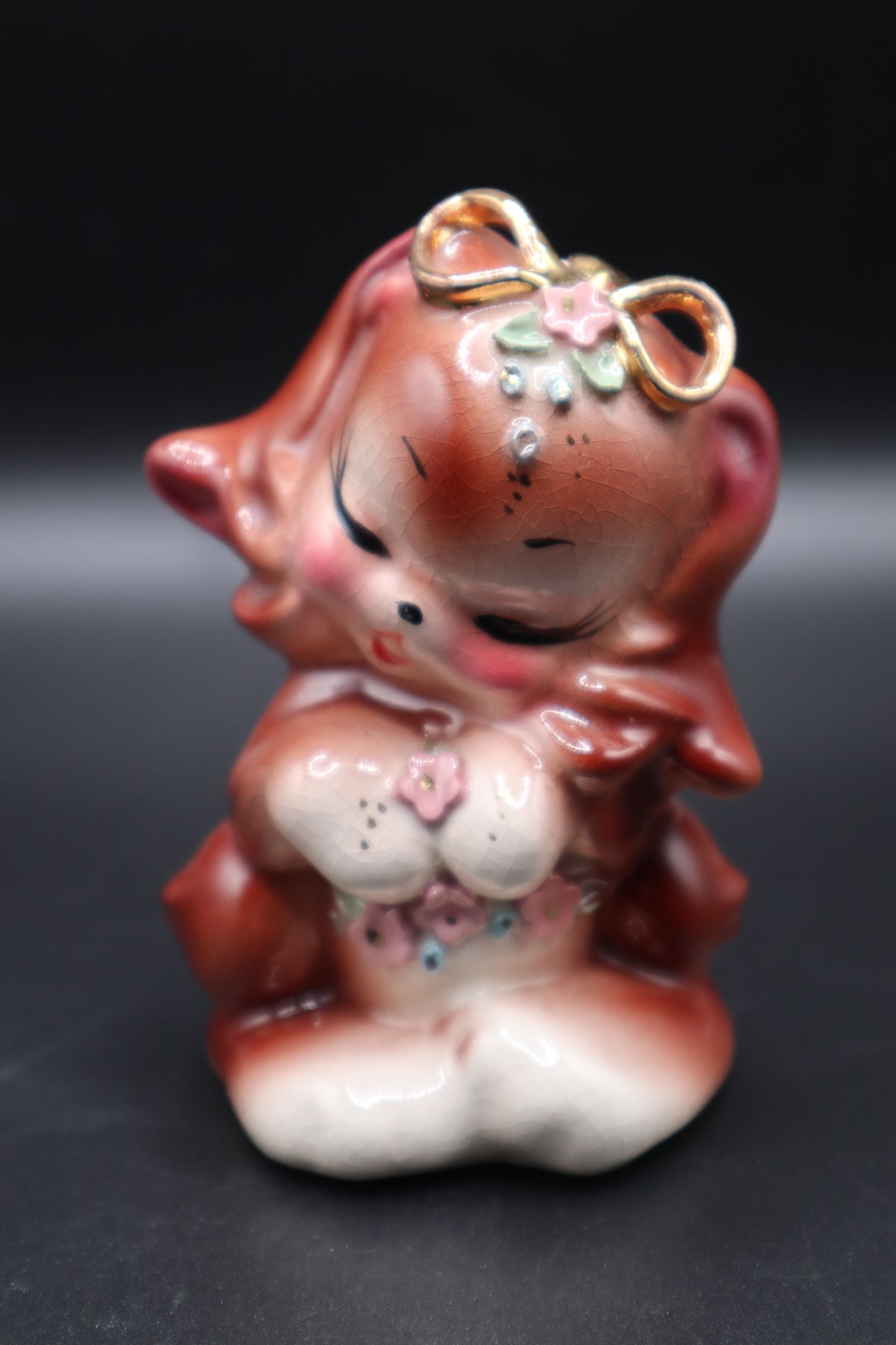 SMALL CERAMIC DOG WITH FLOWERS AND GOLD BOW