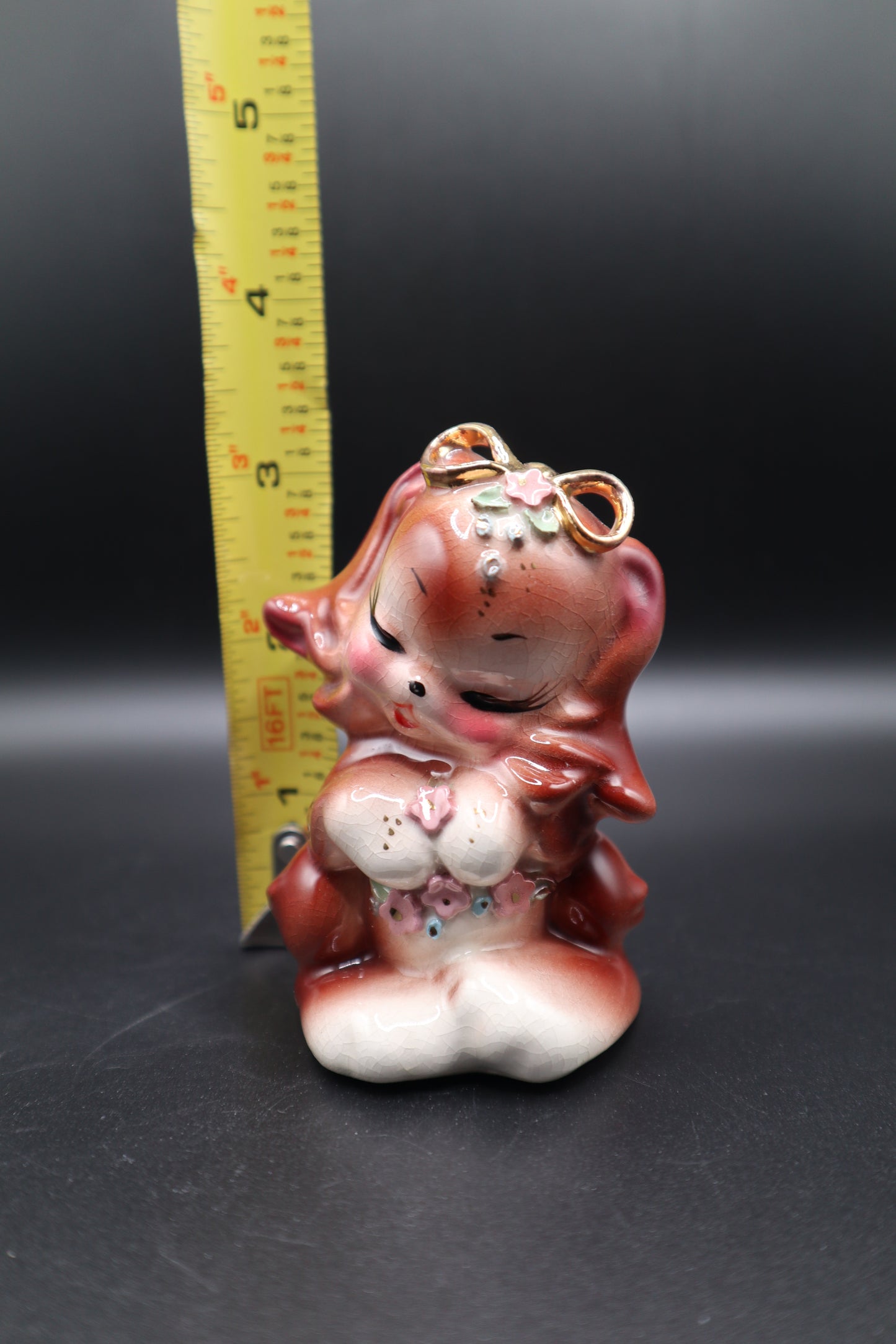 SMALL CERAMIC DOG WITH FLOWERS AND GOLD BOW